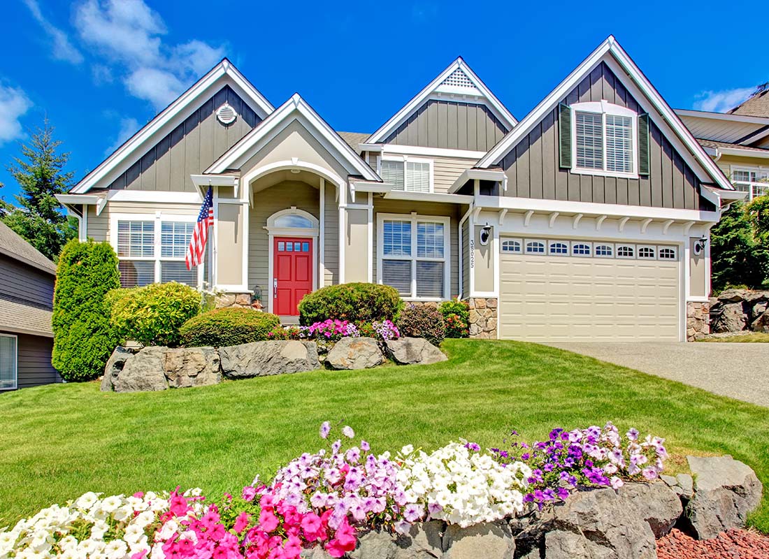 Home-Insurance-Family-Home-with-a-Red-Door-and-American-Flag-Outside